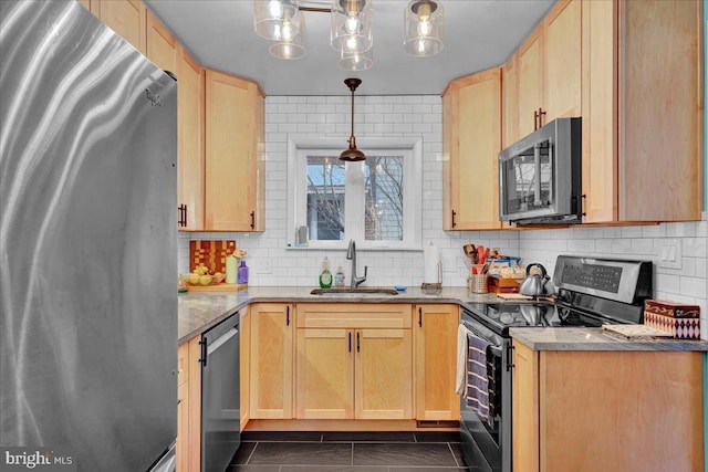 kitchen with decorative light fixtures, sink, light brown cabinets, and appliances with stainless steel finishes