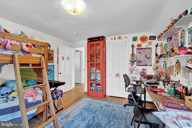 bedroom featuring wood-type flooring and lofted ceiling