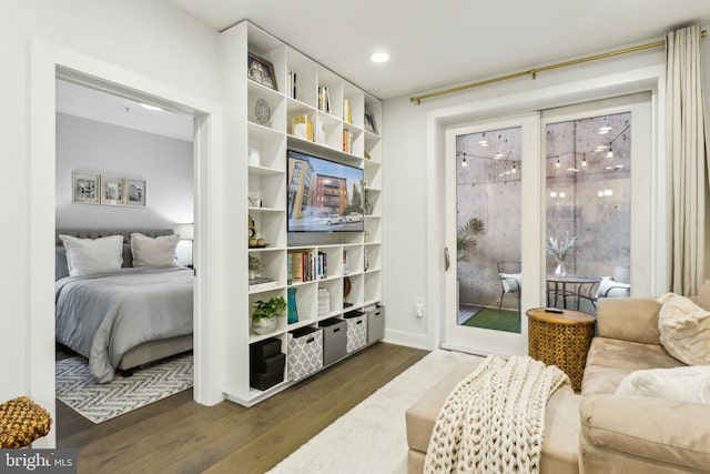 bedroom with dark wood-type flooring and access to outside