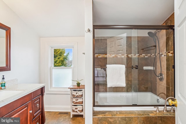 bathroom with vanity and bath / shower combo with glass door