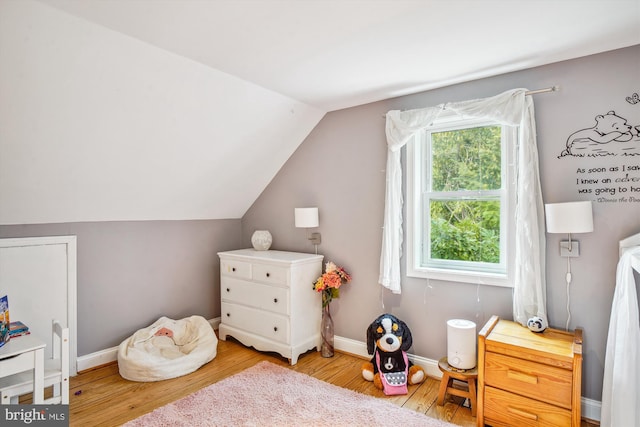 rec room featuring light hardwood / wood-style floors and vaulted ceiling