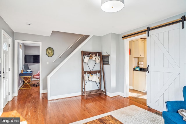 foyer featuring hardwood / wood-style floors and a barn door