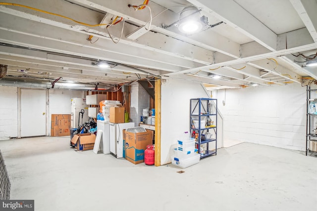 basement featuring white fridge