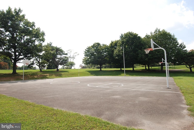 view of basketball court featuring a lawn