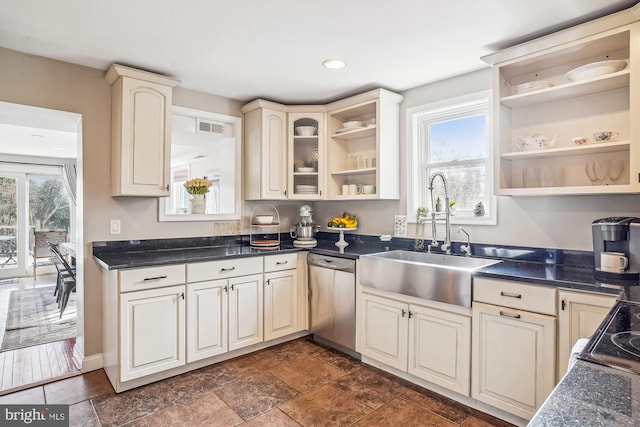 kitchen with cream cabinets, sink, and dishwasher