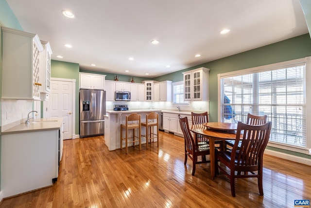 dining room with sink and light wood-type flooring