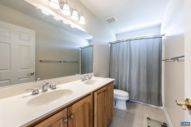 bathroom with tile patterned flooring, vanity, and toilet