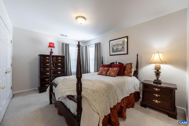 bedroom featuring light carpet