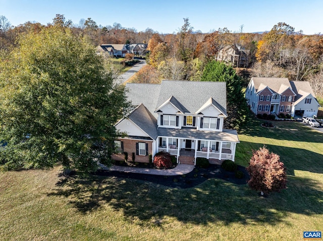 view of front of house featuring a porch and a front yard