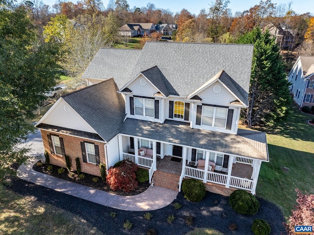 view of front of house with covered porch and a front lawn