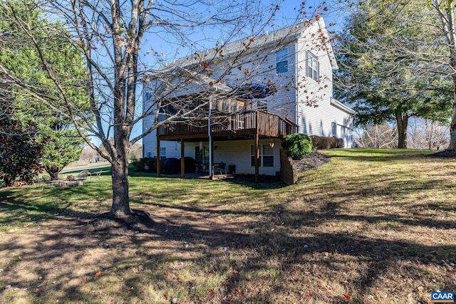 rear view of property with a yard and a deck