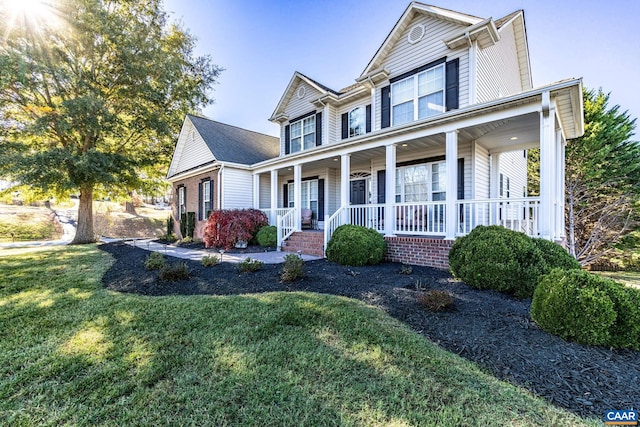 view of front of house with a porch and a front yard