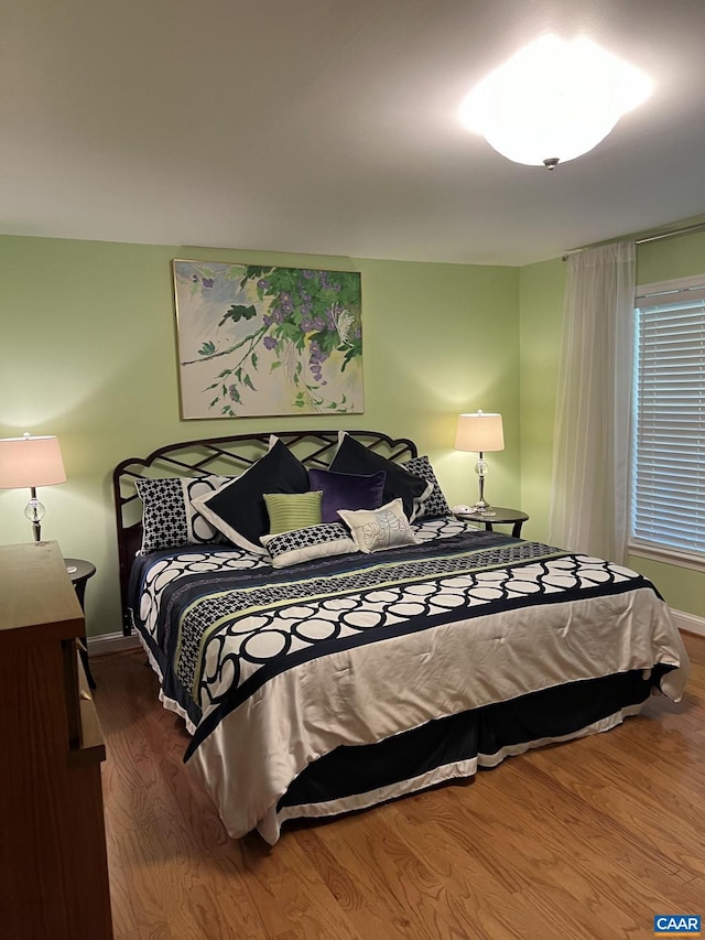 bedroom with dark hardwood / wood-style floors