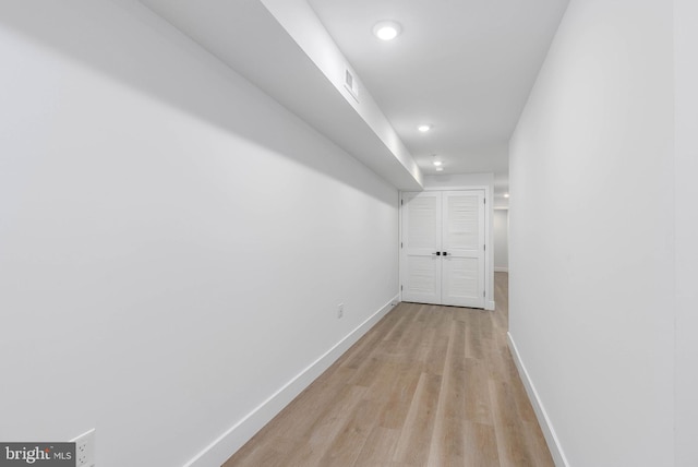 corridor with light wood-type flooring