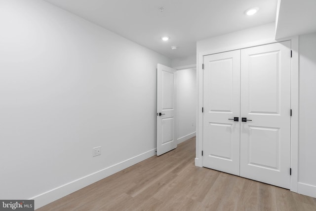 bedroom featuring light hardwood / wood-style floors and a closet