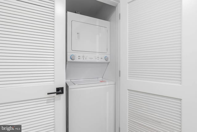 laundry area featuring stacked washer / drying machine