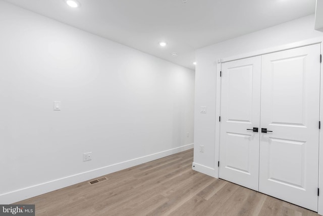 unfurnished bedroom featuring a closet and light hardwood / wood-style flooring