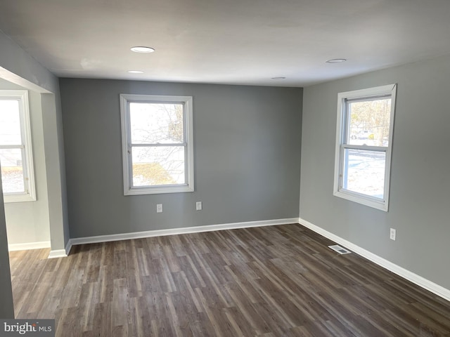 spare room featuring dark hardwood / wood-style flooring