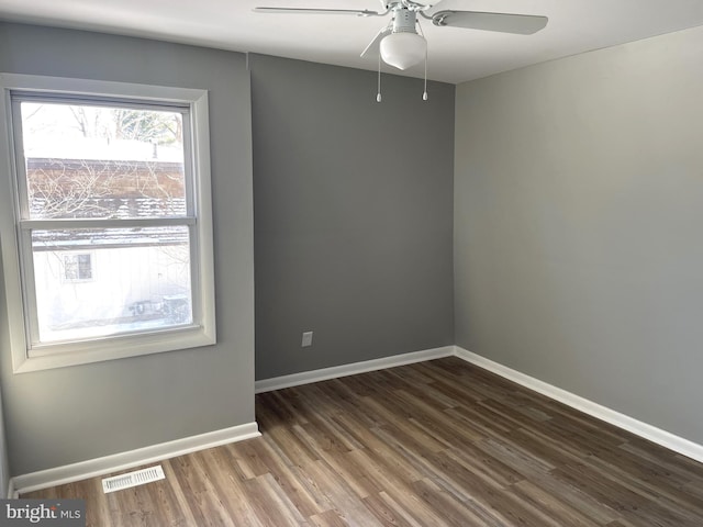 spare room featuring ceiling fan and dark hardwood / wood-style flooring