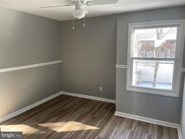 spare room featuring ceiling fan and dark hardwood / wood-style flooring