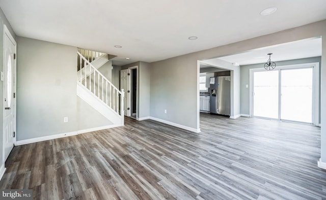 unfurnished living room with wood-type flooring