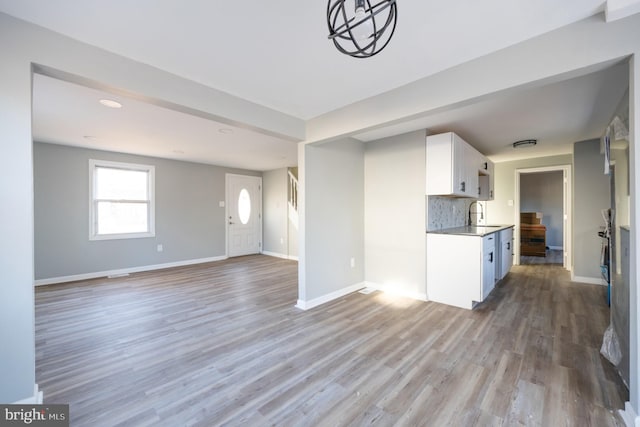 kitchen with sink, hardwood / wood-style floors, and decorative backsplash