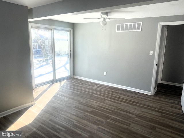 spare room featuring dark hardwood / wood-style floors and ceiling fan