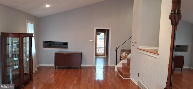 entryway with hardwood / wood-style floors and lofted ceiling