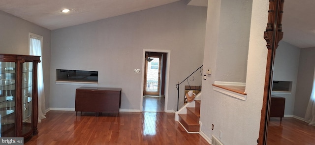 foyer with hardwood / wood-style flooring and vaulted ceiling