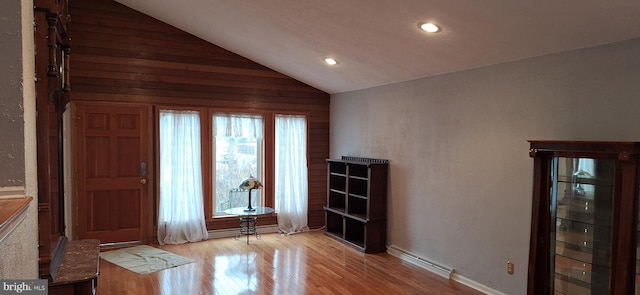 interior space with light hardwood / wood-style floors and lofted ceiling