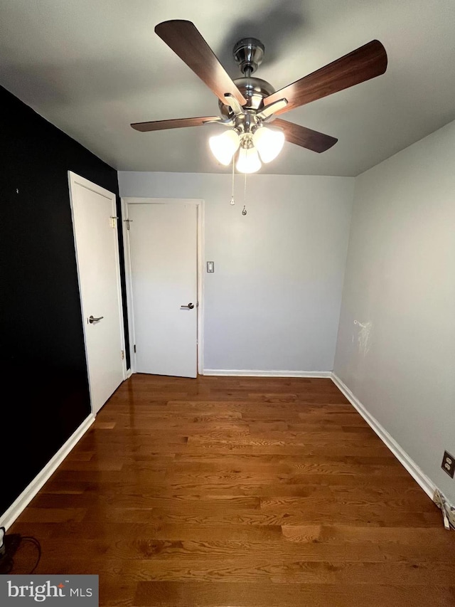 unfurnished room with dark hardwood / wood-style flooring