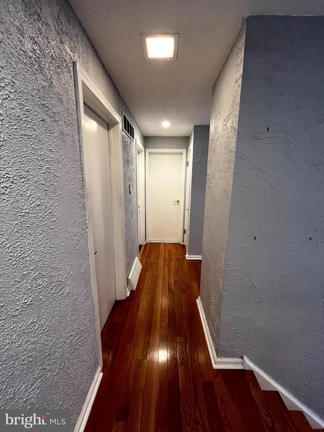 hallway with dark wood-type flooring