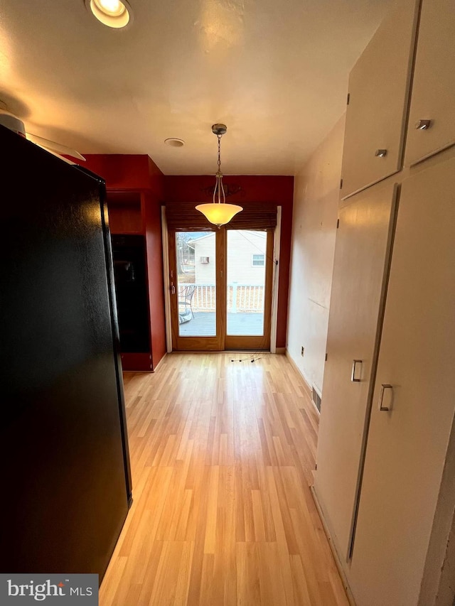 unfurnished dining area featuring light hardwood / wood-style flooring