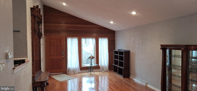 foyer entrance featuring vaulted ceiling and light hardwood / wood-style floors