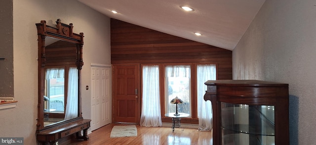 foyer with light hardwood / wood-style flooring and vaulted ceiling