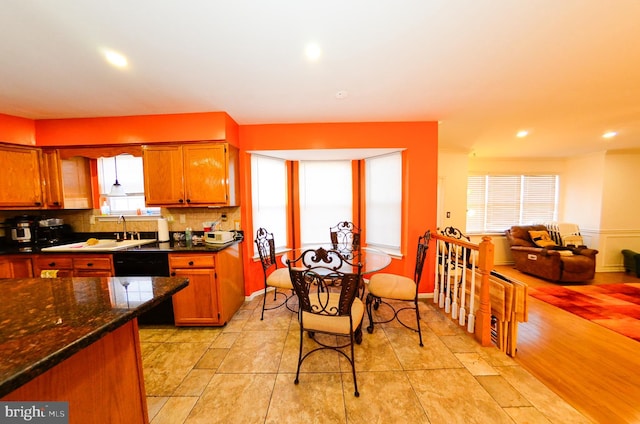 kitchen with tasteful backsplash, sink, and dishwasher