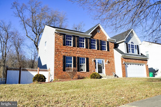 view of front of home with a garage and a front lawn