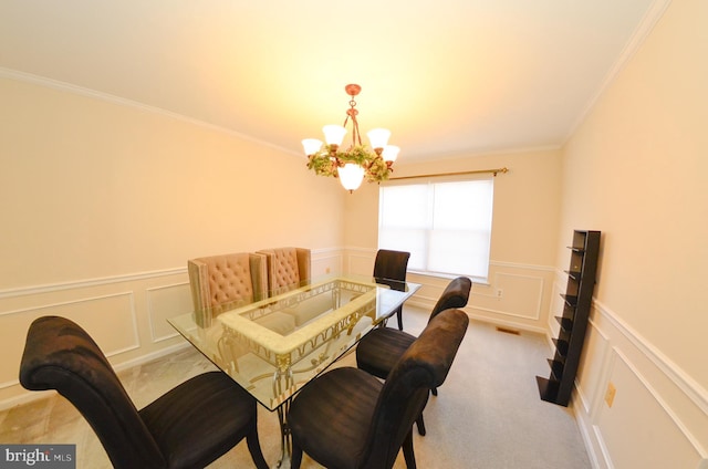 carpeted dining space with ornamental molding and a chandelier