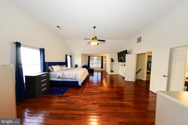 bedroom with dark wood-type flooring and high vaulted ceiling