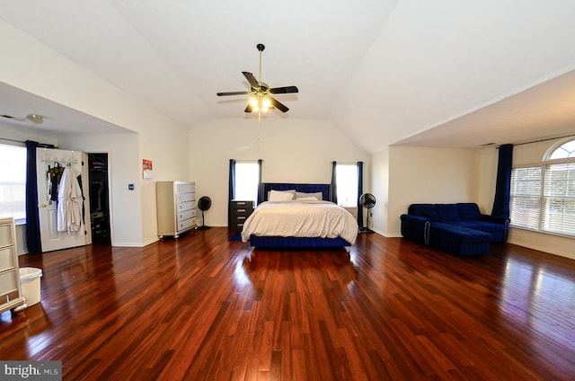 unfurnished bedroom featuring dark hardwood / wood-style flooring, a spacious closet, lofted ceiling, and ceiling fan