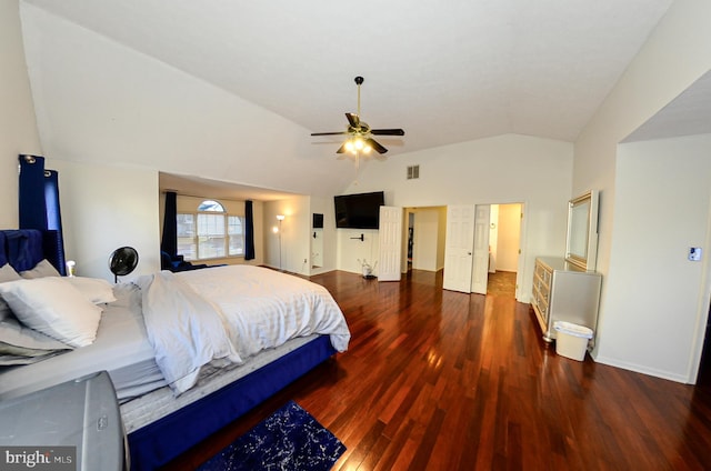 bedroom featuring dark hardwood / wood-style flooring, vaulted ceiling, and ceiling fan