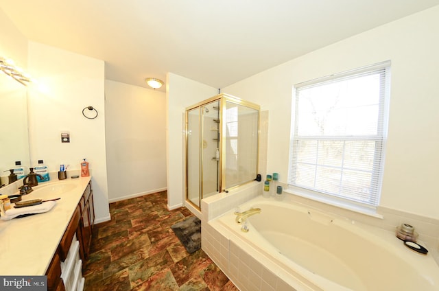 bathroom with vanity and shower with separate bathtub