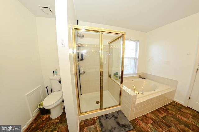 bathroom with hardwood / wood-style floors, toilet, and separate shower and tub