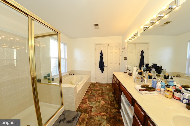 bathroom with vanity and separate shower and tub