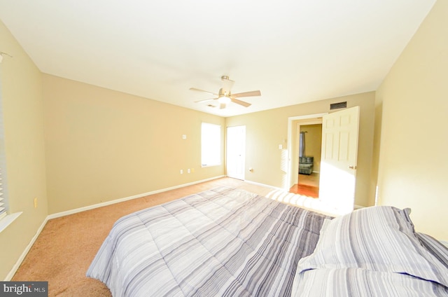 bedroom with ceiling fan and light colored carpet