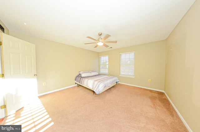 unfurnished bedroom with ceiling fan and light colored carpet