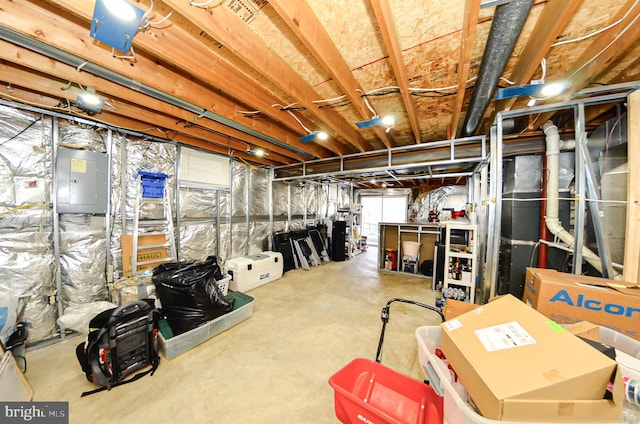 basement featuring electric panel and water heater