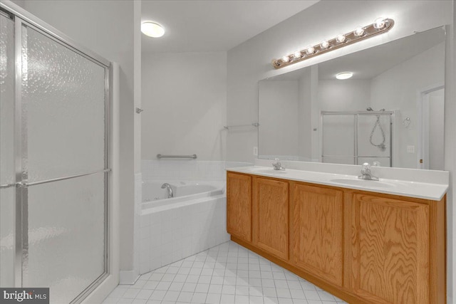 bathroom featuring tile patterned floors, vanity, and plus walk in shower