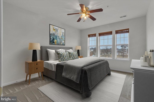 bedroom with ceiling fan and light colored carpet