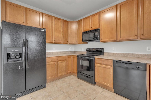 kitchen featuring light tile patterned floors and black appliances